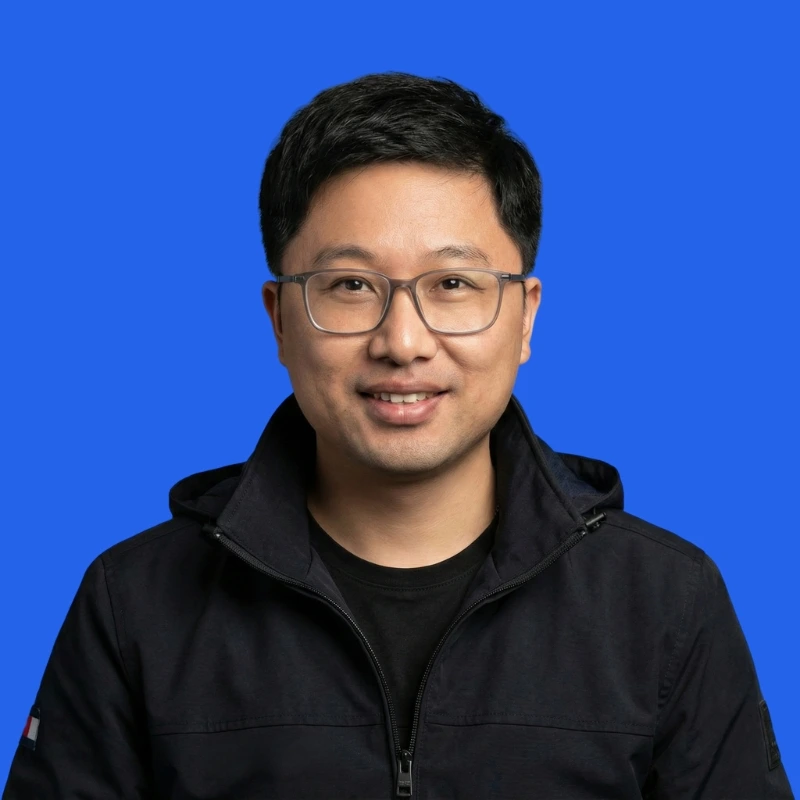 Xiaoyi Lu, Co-Founder and CTO of Meet George, in a professional profile photo with a blue background.